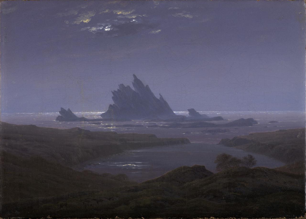 Painting in shades of blue. In the foreground you can see a rocky coast. In the background a rocky reef in the sea.