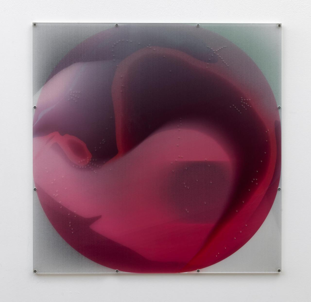 Round, red collage under plexiglass