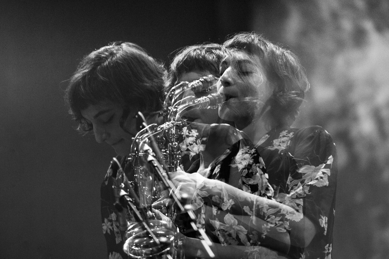 An artfully flowing black and white picture of Lea Bertucci on saxophone