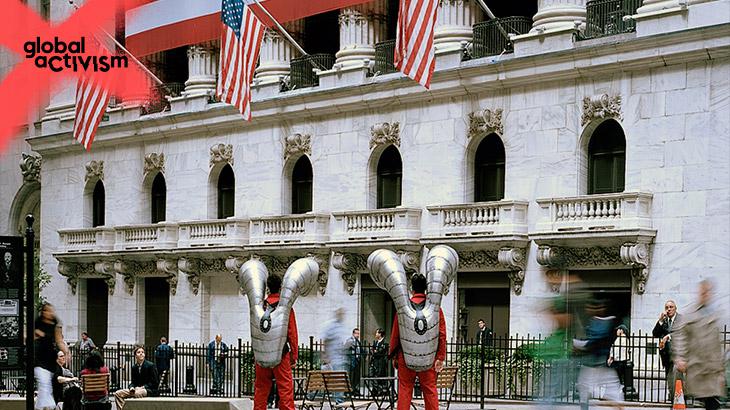 Two men in futuristic suits are standing in front of the New York' bourse