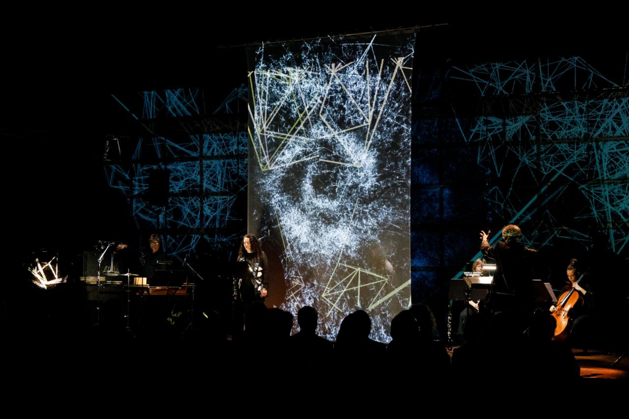 Musicians in front of an LED wall with visualizations
