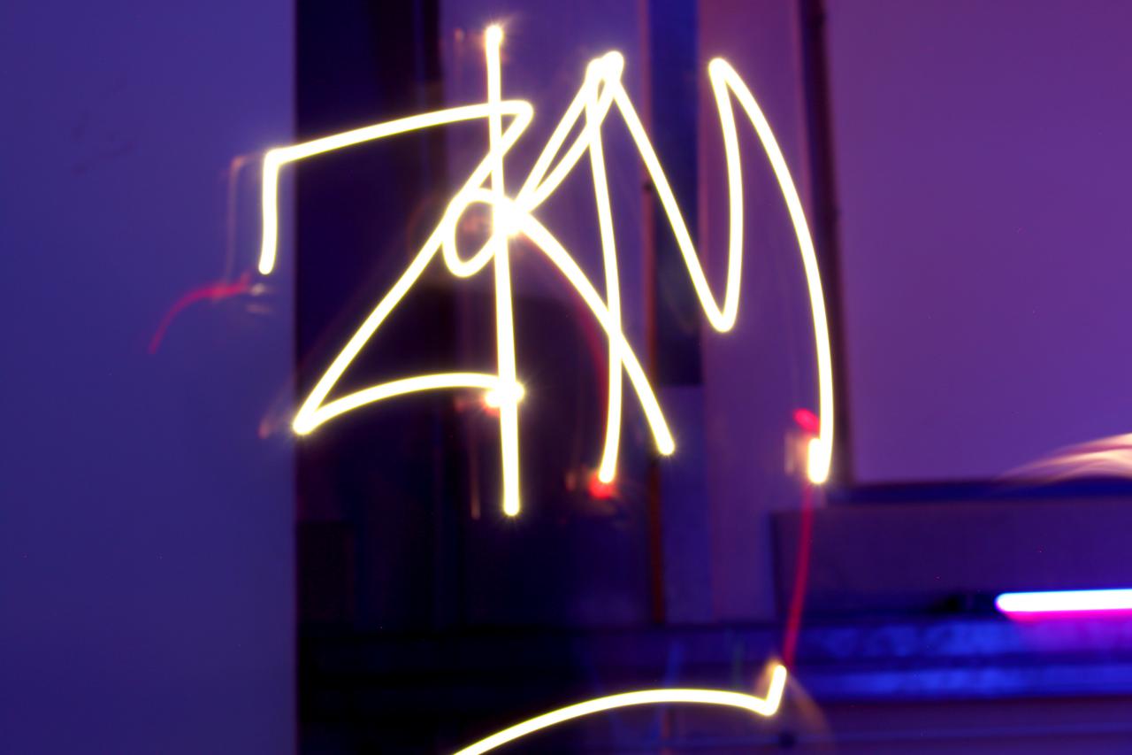 The word ZKM can be seen in luminous lettering made of light sticks at an event of the cultural academy.