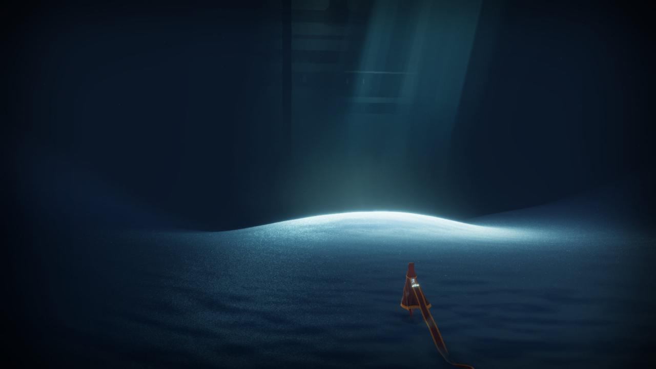 Die Spielfigur befindet sich in einer dunklen Höhle. In der Mitte der Hähle fällt helles Licht auf den bläulichen Sand