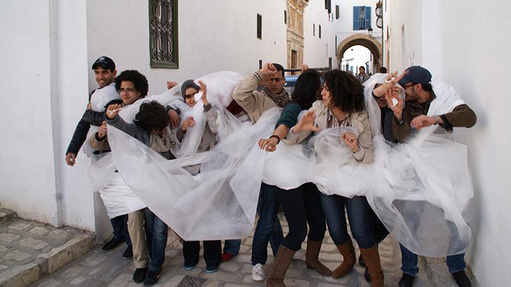 A group is winding in a white ribbon