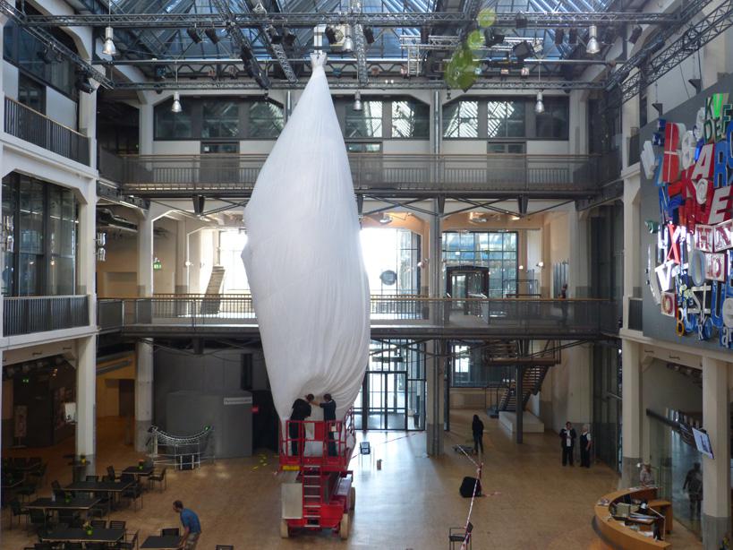 A white fabric is hanging in an atrium