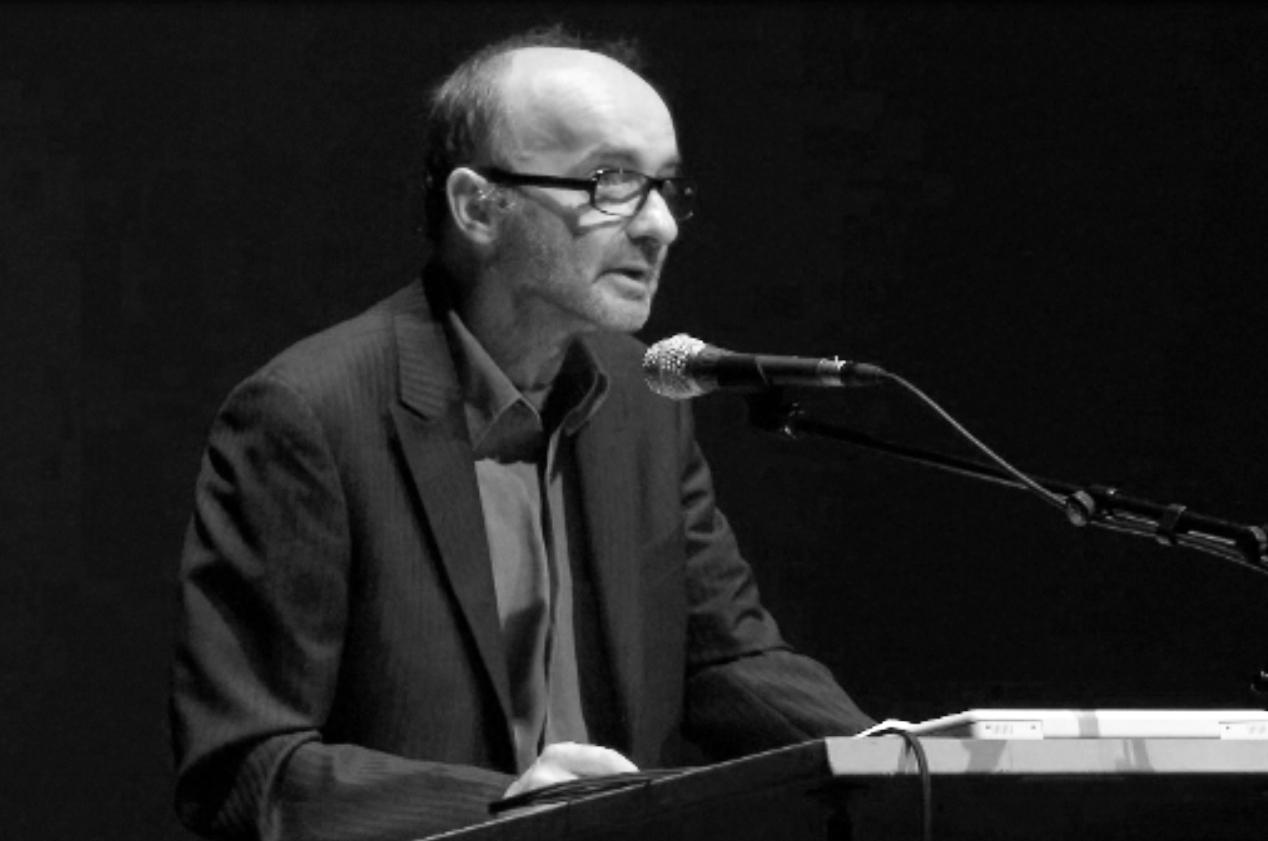Christoph Blase at the lectern with microphone