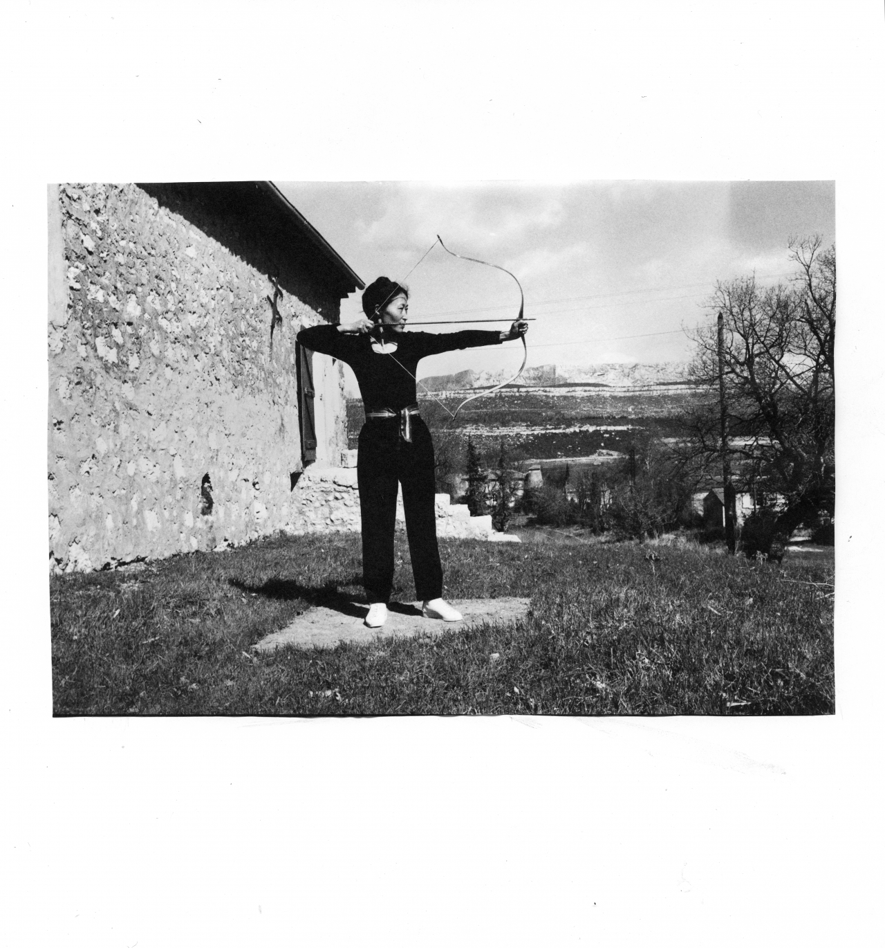 Soun-Gui Kim with Bow and Arrow, black and white