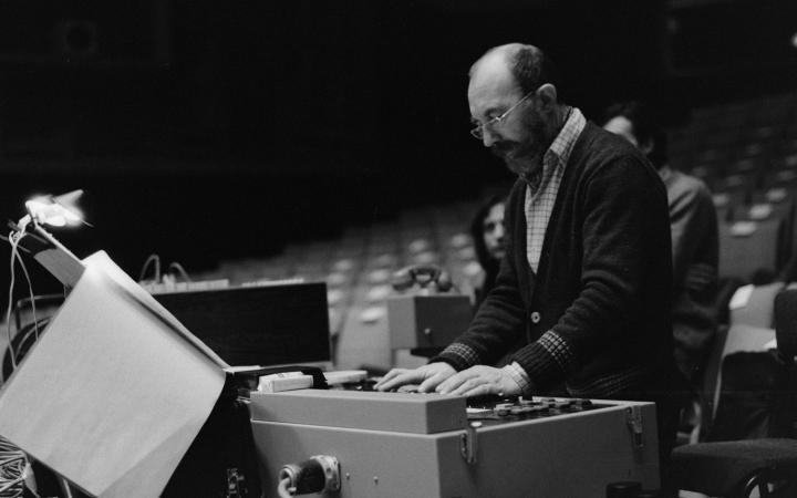 A man standing at a sound mixer