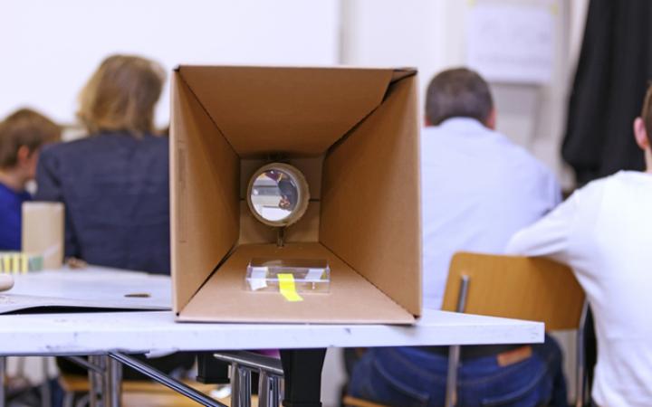 selfmade projector out of cardboard is lying on a table
