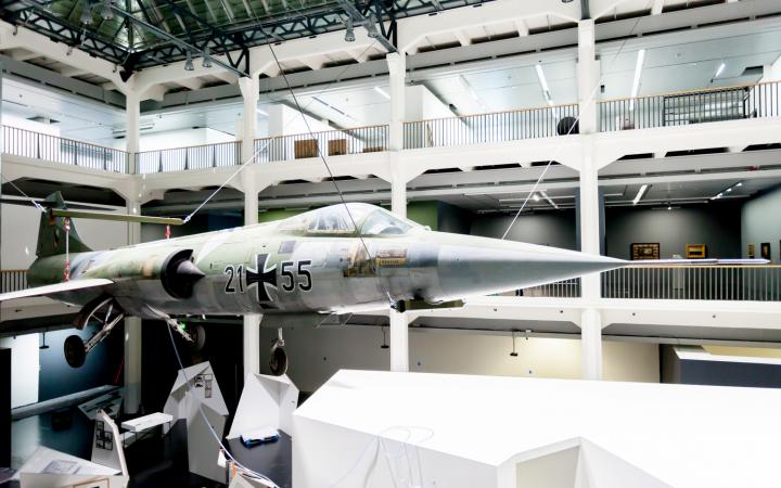 A starfighter which is hanging from the ceiling in the museum