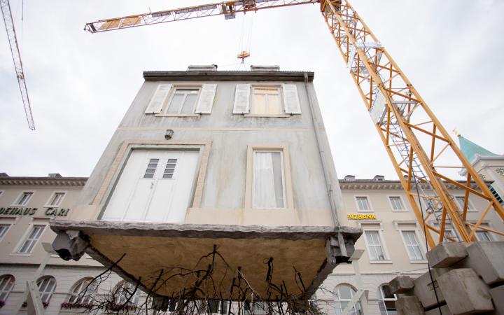 A House hangs on a crane
