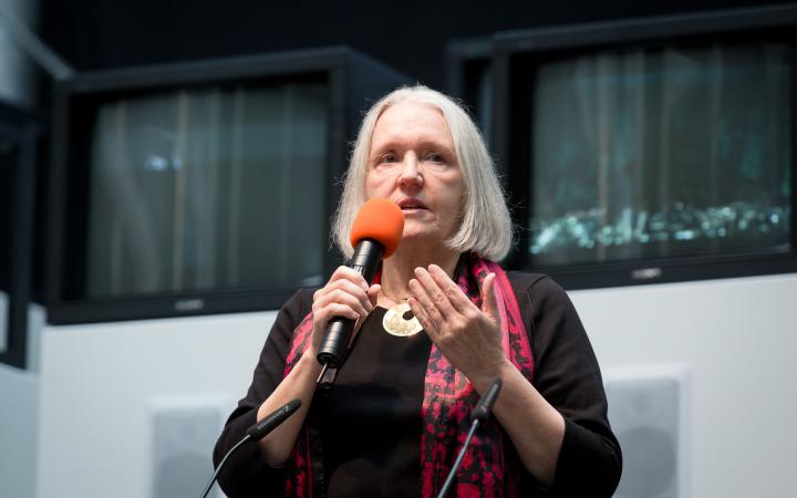 A woman talking into a microphone