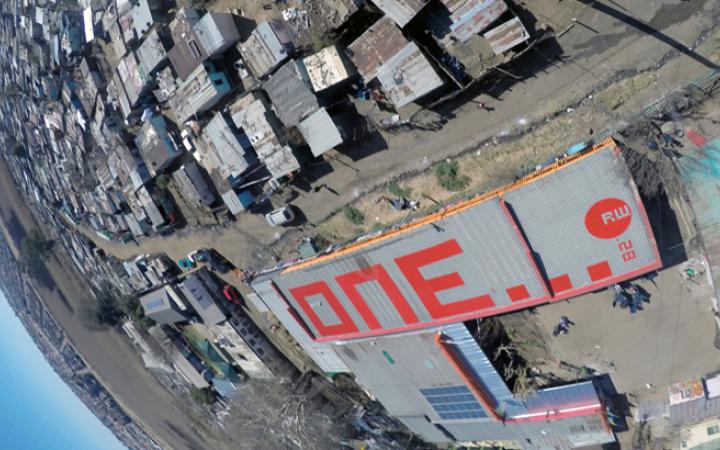 The word "one" in red letters on a roof