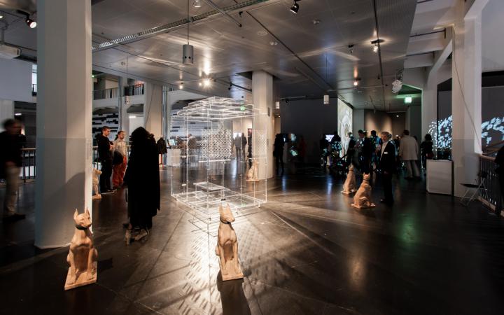 People in the exhibition space. In the foreground a dog-plastic