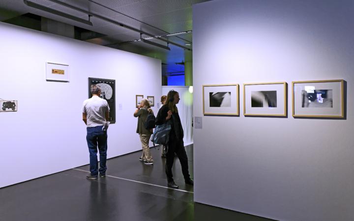 People looking at paintings on the wall