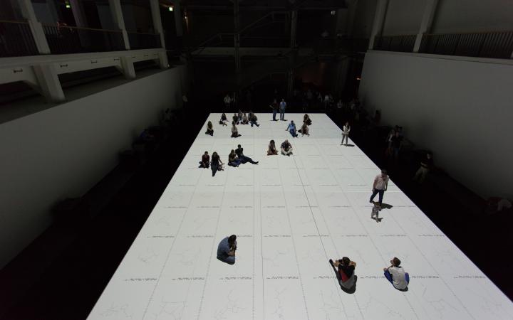 People standing on a white projection