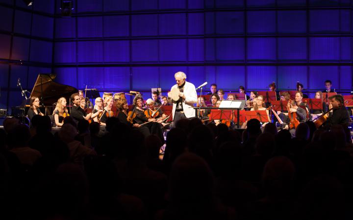 David Amram in front of an orchestra
