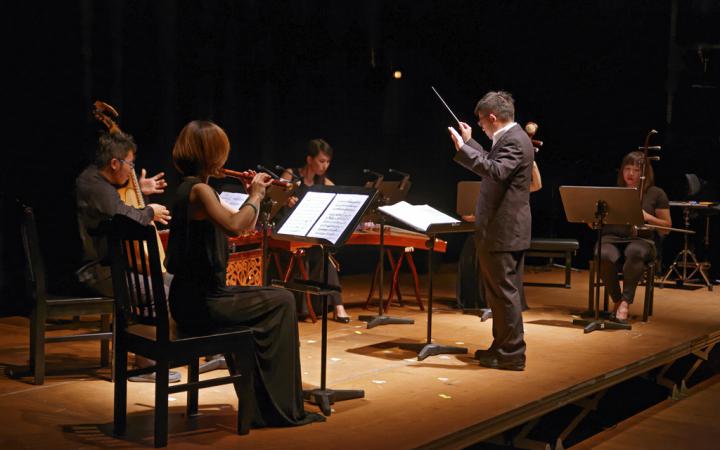 A four-piece orchestra with a conductor