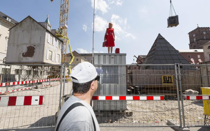 A woman standing in the middle of a construction site