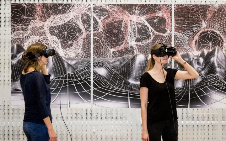Two women look through VR glasses 