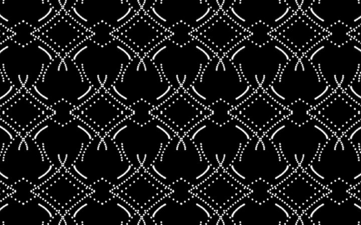 An arrangement of white dots as a graphic pattern on a black background