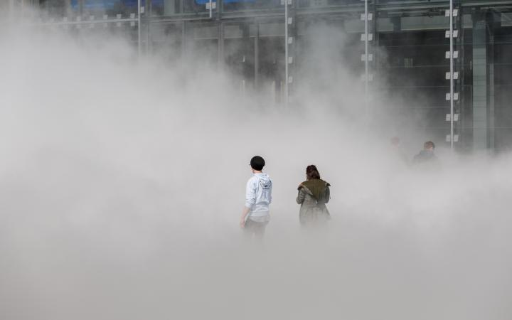 The picture shows the fog sculpture by the artist Fujiko Nakaya in front of the ZKM
