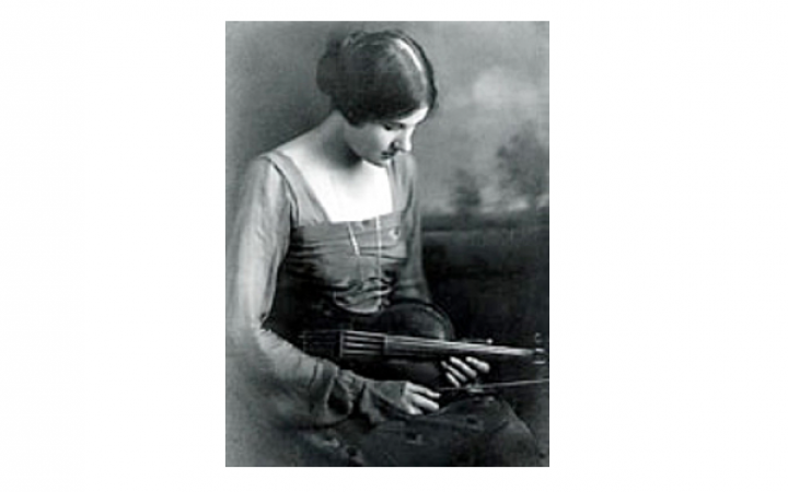 A photograph with the portrait of a young woman with a viola.