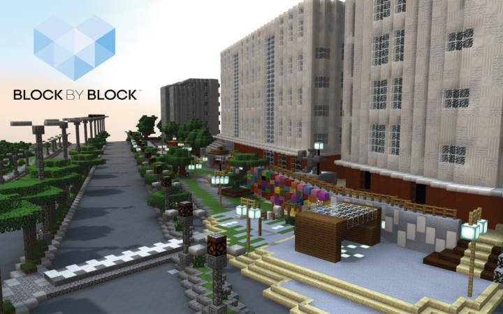 Block by Block logo in the top left corner of the image. 3D model of an urban space in the game Minecraft. House facades are shown in the right part of the image. A street is shown in the centre of the image. Between the two parts of the image are 