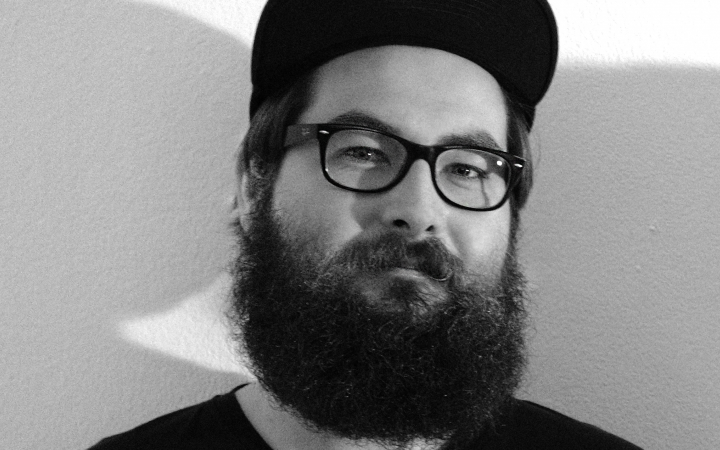 Black and white portrait of a man with glasses and full beard