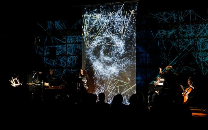 Musicians in front of an LED wall with visualizations