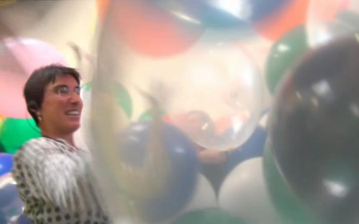 A woman surrounded by balloons