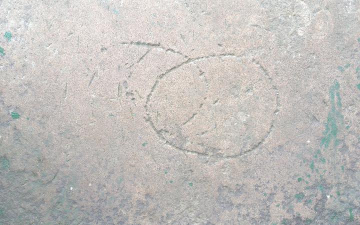 Circular shapes carved on a stone surface.