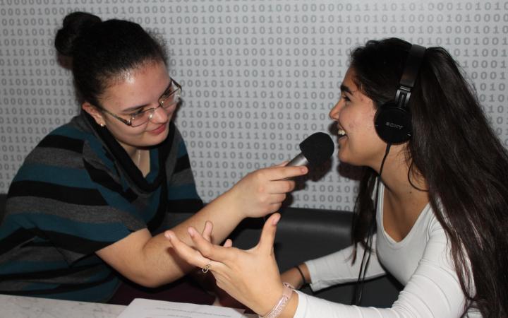 Zwei Schülerinnen die sich gegenseitig interviewen im Rahmen der Veranstaltung »Global Sound«. 