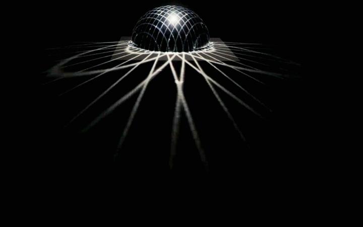  An illuminated black ball throws rays into a dark room