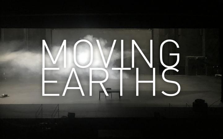An abandoned stage with a table and a chair, from the left fog is streaming through the picture and it is written large in the foreground: "Moving Earths".