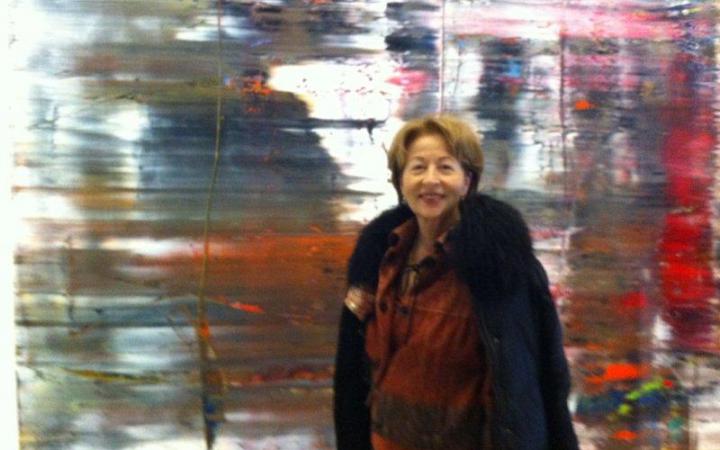 Portrait of a woman in front of a blurred picture