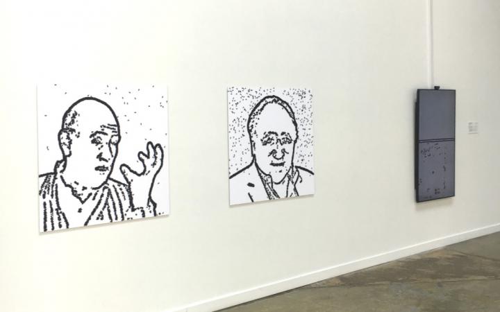 Two portrait drawings on the wall 