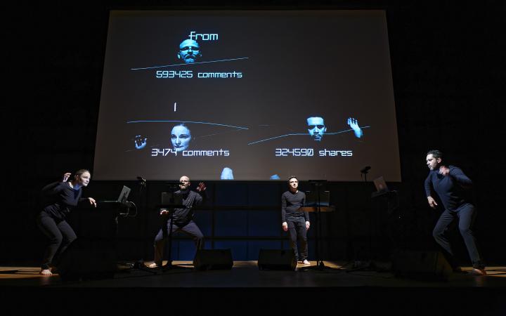 Four artists on stage in front of a screen