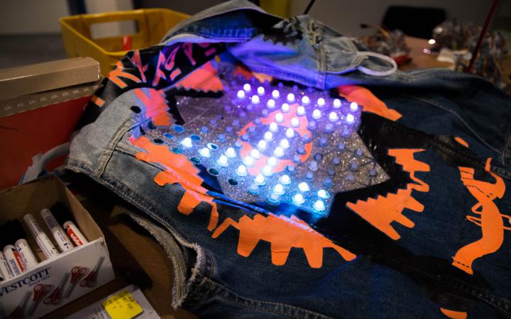 Jeans jacket with LEDs laying on a table 