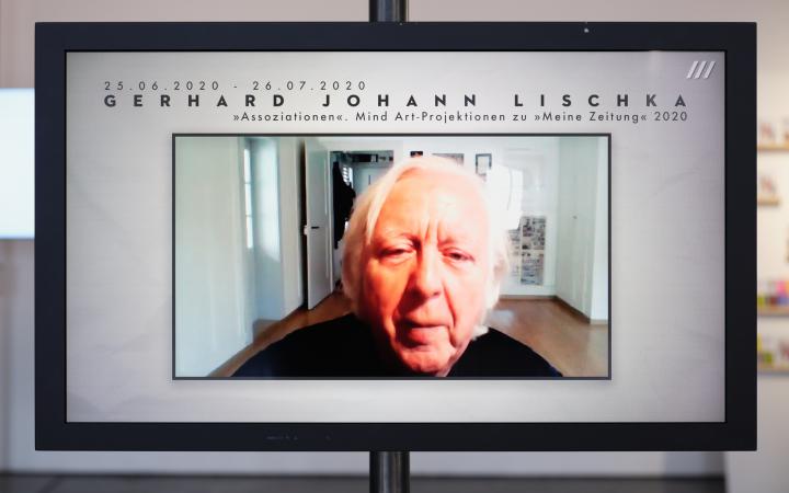 A screen can be seen on which the face of an old man plays. Above the man's head is the name Gerhard Johann Lischka. 
