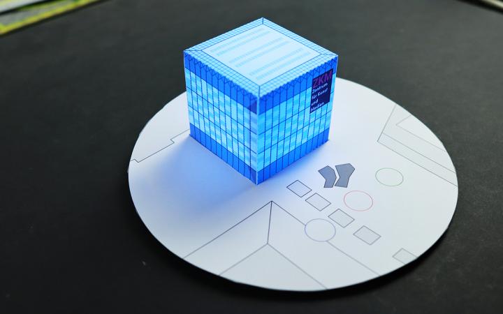 A miniature of the ZKM cube for DIY, which glows blue.