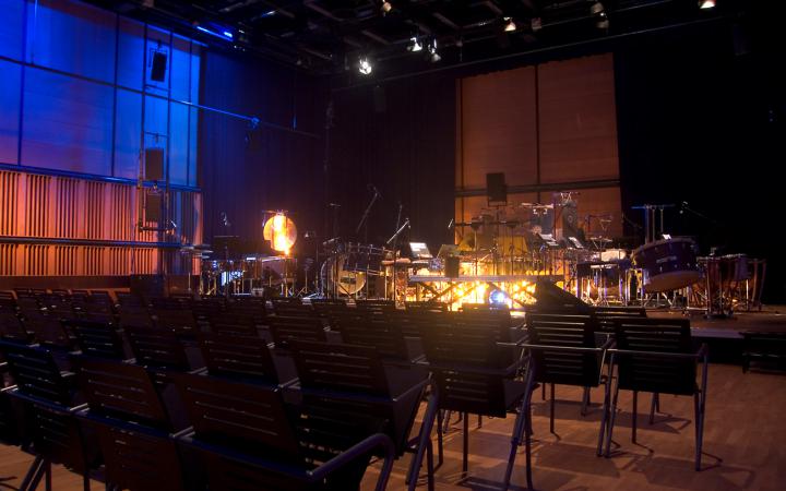 Leere Reihenbestuhlung im ZKM_Kubus mit Orchesteraufbau auf der Bühne
