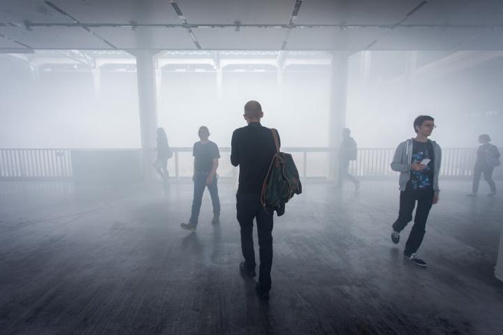People walking through fog