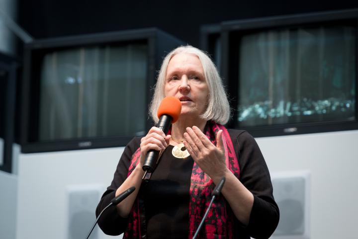A woman talking into a microphone