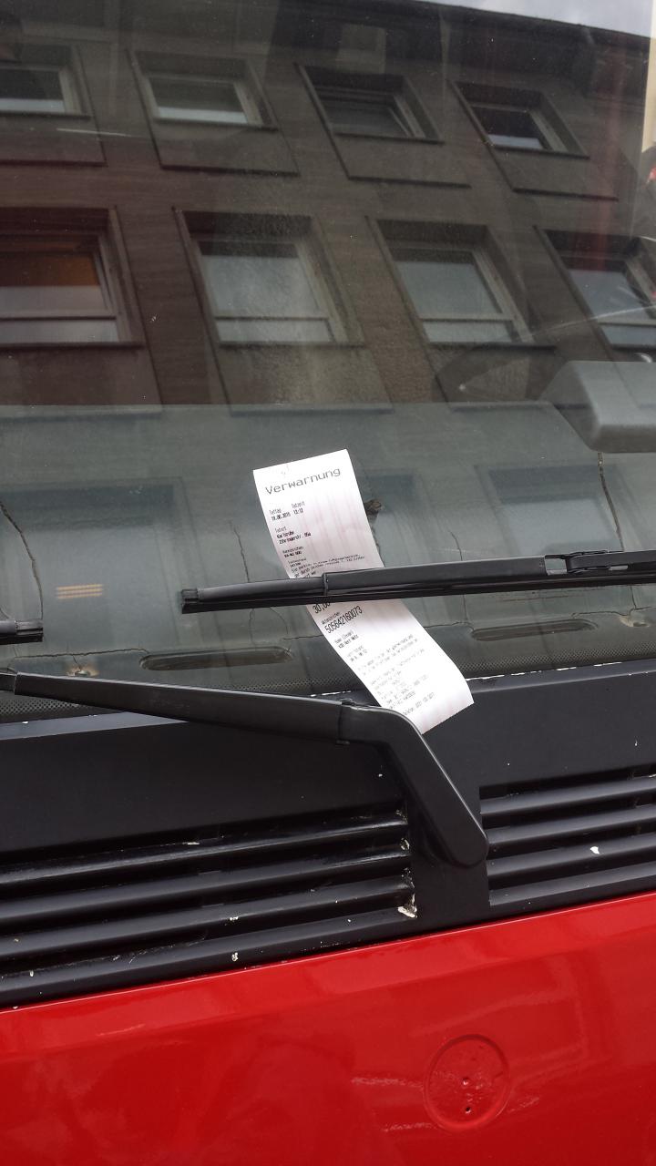 Close-up of a speeding ticket in the windscreen of a red truck