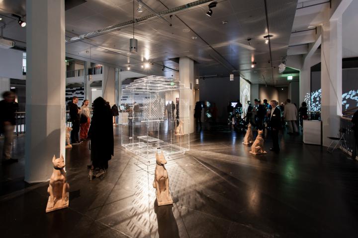 People in the exhibition space. In the foreground a dog-plastic