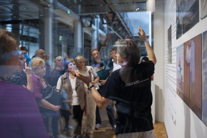 People standing in front of a picture