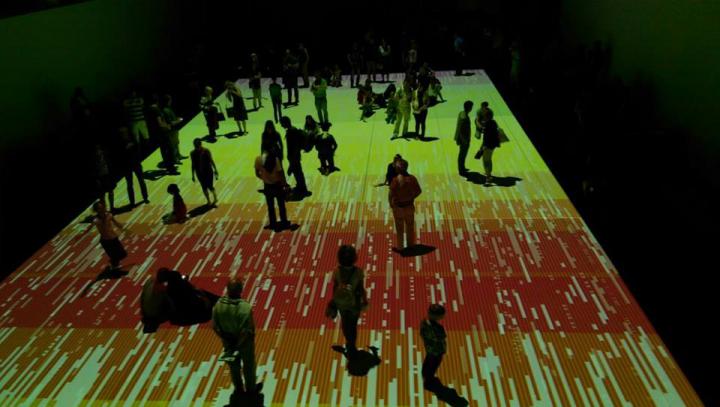 People standing on a colored projection