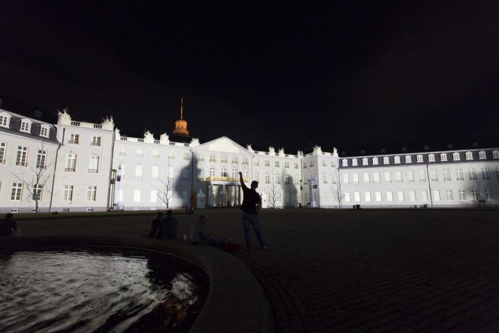The palace facade within white lights