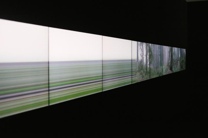 A screen on which a landscape disappears and merges into stripes